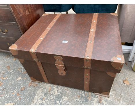 A MODERN TRUNK WITH LEATHER STRAPS 