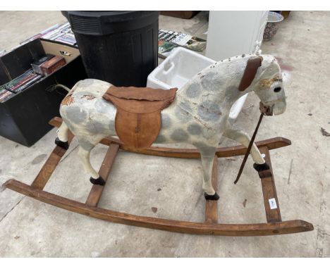 A VINTAGE WOODEN AND FIBRE GLASS CHILDS ROCKING HORSE 