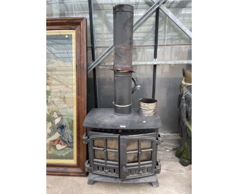 A CAST IRON LOG BURNER WITH FLU PIPE AND BRACKETS 