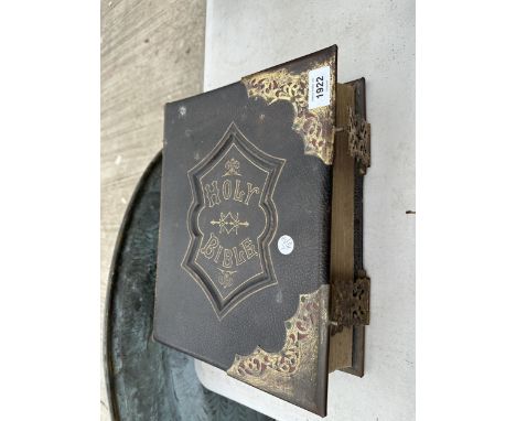 A VINTAGE LEATHER BOUND HOLY BIBLE WITH BRASS DETAIL 