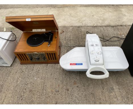 A RETRO STYLE PORTABLE RECORD PLAYER AND A CLOTHES PRESS 