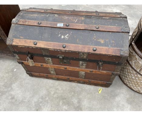 A VICTORIAN COMPRESSED FIBRE DOME TOPPED TRUNK WITH METAL FITTINGS AND WOODEN SLATS 30" WIDE 