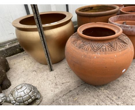 A TERRACOTTA PLANTER AND A FURTHER GILT TERRACOTTA PLANTER 