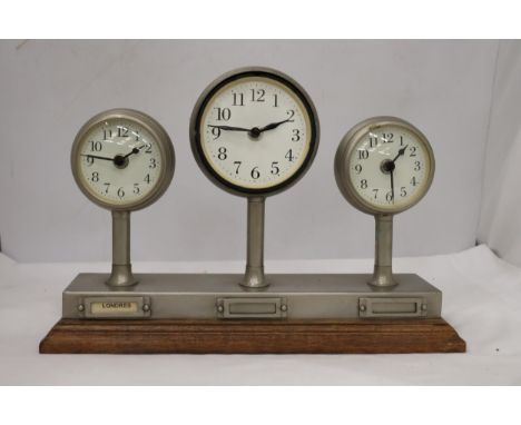 A CLOCKS OF THE WORLD MANTLE CLOCK ON A WOODEN STAND, HEIGHT 24CM, LENGTH 36CM 