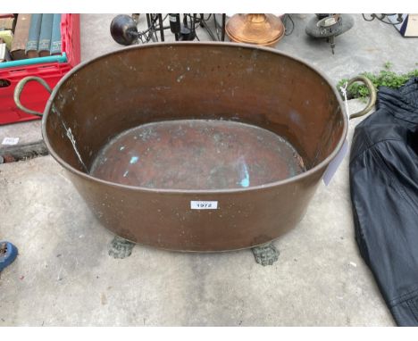 A VINTAGE COPPER TWIN HANDLED PLANTER WITH LION PAW FEET 