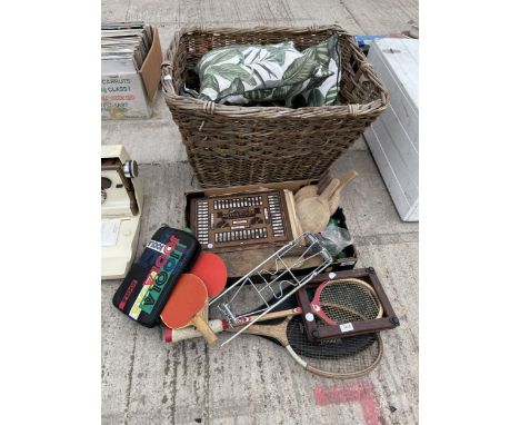 AN ASSORTMENT OF ITEMS TO INCLUDE A LARGE WICKER LOG BASKET, TENNIS RACKETS AND A VINTAGE AUTOBRIDGE PLAYING BOARD ETC 