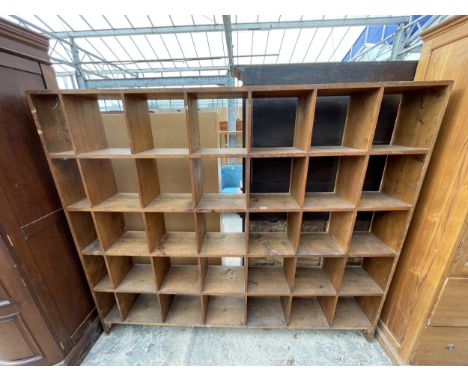 A THIRTY FIVE DIVISION PIGEON HOLE OPEN STORAGE SHELF 83" WIDE, 71" TALL AND 11" DEEP 