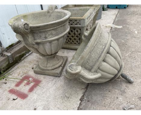 A CONCRETE GARDEN URN PLANTER WITH BASE AND A FURTHER URN PLANTER LACKING THE BASE 