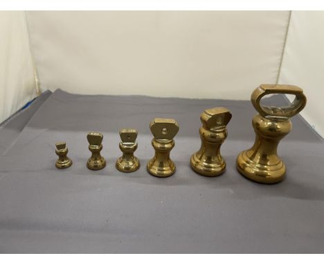 A COLLECTION OF VINTAGE BRASS BELL WEIGHTS 
