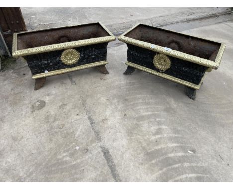 A PAIR OF VINTAGE DECORATIVE BLACK AND GOLD PAINTED CAST IRON TROUGH PLANTERS 