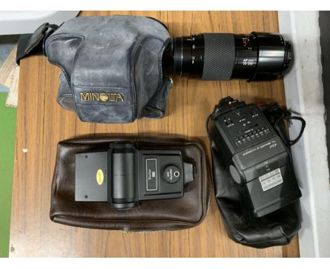 A CASED MINOLTA CAMERA WITH EXTRA LENS AND FLASHES 