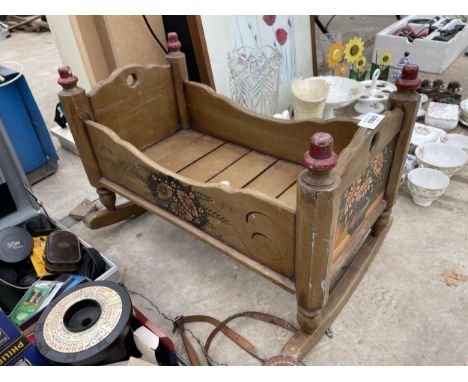 A VINTAGE WOODEN ROCKING DOLLS CRIB 