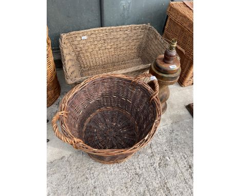 TWO LARGE WICKER LOG BASKETS AND A DECORATIVE WOODEN TABLE LAMP 