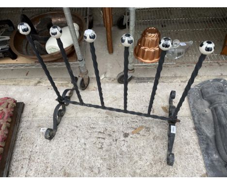 A VINTAGE WROUGHT IRON WELLY STAND WITH CERAMIC KNOBS 