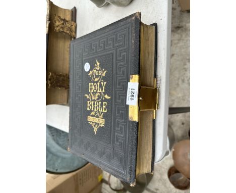 A VINTAGE LEATHER BOUND BIBLE WITH BRASS DETAIL 
