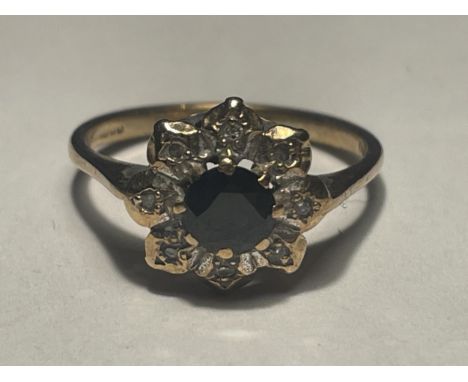 A 9 CARAT GOLD RING WITH CENTRE SAPPHIRE SURROUNDED BY DIAMONDS IN A FLOWER DESIGN SIZE M 