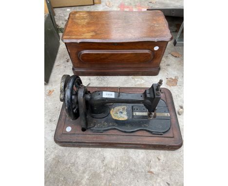 A VINTAGE SEWING MACHINE WITH WOODEN CARRY CASE 