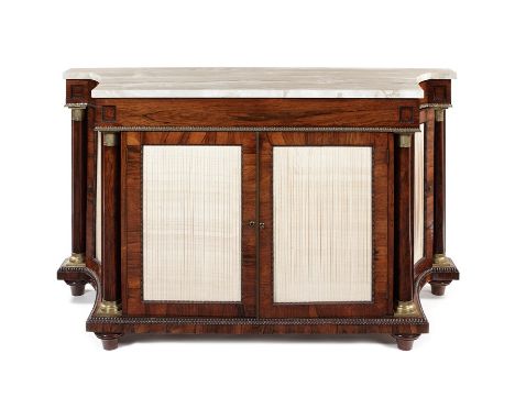 A Regency rosewood side cabinet
The veined white marble top with deep curved sides over a long frieze drawer, the sides and f