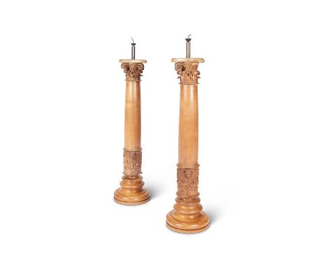 A pair of tall late 19th century walnut corinthian column lamp bases
On turned socle bases, fitted for electricity, each 95cm