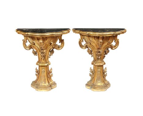 A pair of 18th century Italian carved gilt wood console tables
The shaped green veined faux marble top on moulded shaped supp