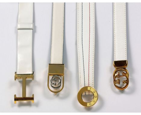Three of various Gucci logo designs, enamel, silver and gold-tone buckles, the largest 4,5cm long by 2,5cm wide, the longest 