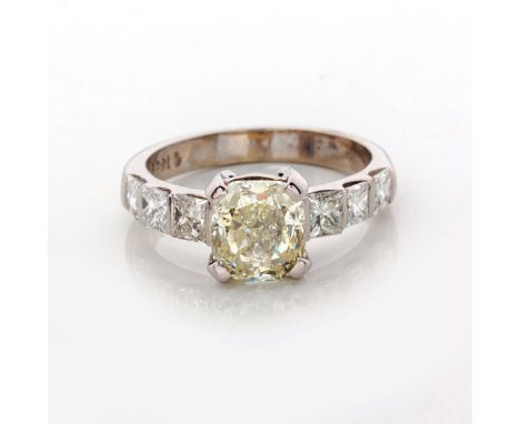 Claw set to the centre with a cushion-cut diamond weighing approximately 2.06ct, colour range very light to light yellow, cla