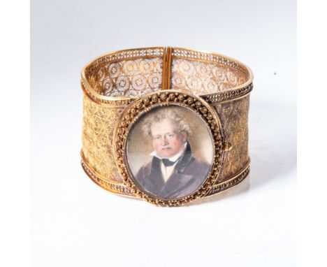 Designed as a broad band of filigree and cannetille work, centred with an oval-shaped miniature portrait of a gentleman, acid