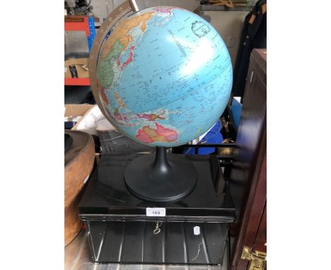 A terrestrial globe and a metal deed box 