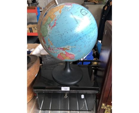 A terrestrial globe and a metal deed box 