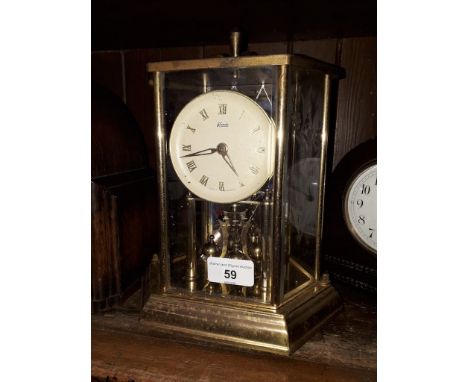 A Kundo revolving pendulum clock, height 25cm. 