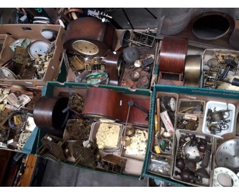 Seven boxes of assorted clock parts including movements, spares etc. 