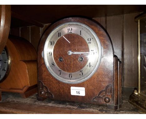 An oak domed mantle clock striking on single coil, height 23cm. 