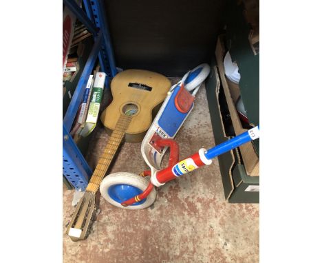 A child's scooter and a child's guitar 