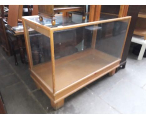 A vintage glazed shop display cabinet 