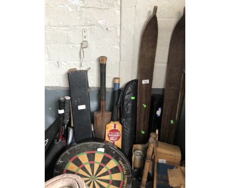 A selection of sporting equipment including snooker cues, dartboard, cricket bat, squash and tennis racquets, and a pair of v