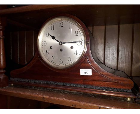 A domed mahogany chiming mantle clock with brass bun feet, length 47.5cm. 