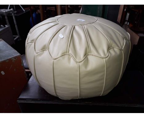 A cream leather pouffe 