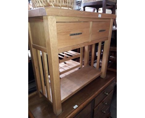 A light oak two drawer side table with lower tier 