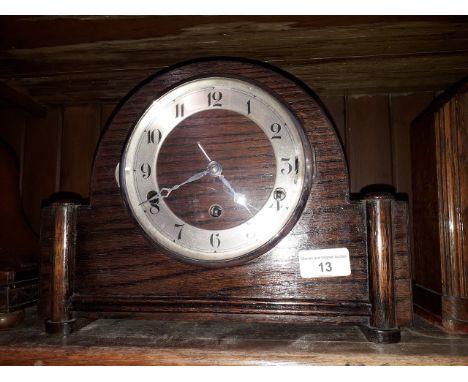 An oak domed top chiming mantle clock, height 22cm. 