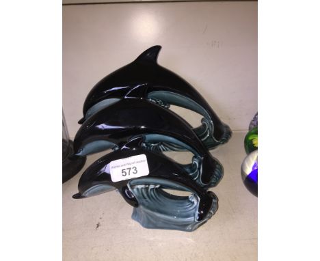 Three Poole pottery graduated dolphins 