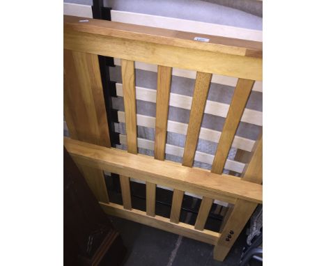 A light wood double bed frame 