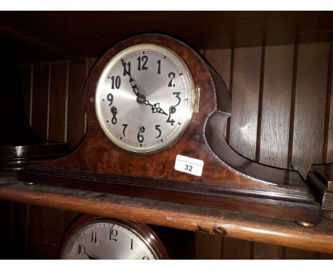 A burr walnut chiming mantle clock with brass bun feet, length 45cm. 