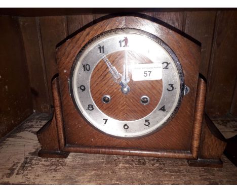 A 1930s oak mantle clock striking on single coil, height 21cm. 