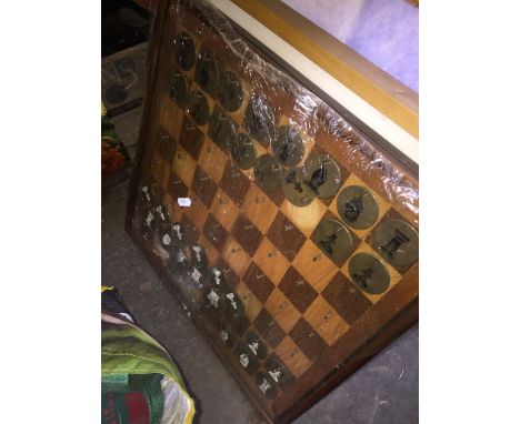 A framed set of book covers, a picture and print, and a hanging correspondence chess set 