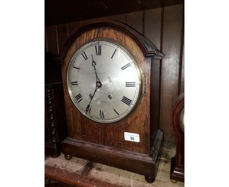 An Edwardian domed oak mantle clock, the silver dial with Roman numerals and signed M Beaver Ltd Manchester, double spring dr