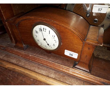 An Edwardian Arts &amp; Crafts style oak mantle clock, signed Thomas Russell &amp; Son Liverpool, length 29cm. 