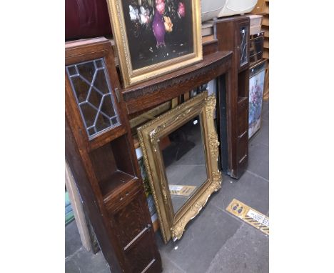 A 1920s oak fire surround with side leaded glass cupboards including a pipe rack and slide out cup shelves 