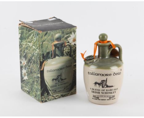 A ceramic jug containing Tullamore Dew Whiskey. A blend of Rare old Irish Whiskey (1960s). Comes with original box. 