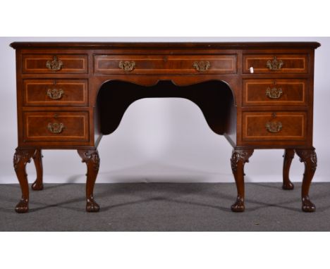 George III style mahogany desk, serpentine top with broad crossbanding and herringbone stringing, the kneehole surrounded by 