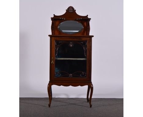 An Edwardian mahogany display cabinet, raised superstructure with carved pediment above shelves, oval bevelled mirror, scroll